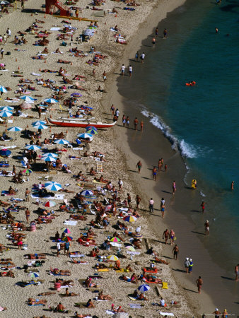 Crowds On Waikiki Beach, Usa by Lee Foster Pricing Limited Edition Print image