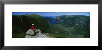 Person Sitting On Cliff, Ten Mile Pond, Gros Morne National Park, Newfoundland And Labrador, Canada by Panoramic Images Pricing Limited Edition Print image