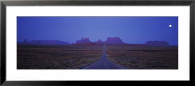 Highway Passing Through An Arid Landscape, Monument Valley, Arizona, Usa by Panoramic Images Pricing Limited Edition Print image