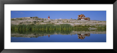 Reflection Of A Lighthouse And A House On The Water, Bohuslan, Sweden by Panoramic Images Pricing Limited Edition Print image