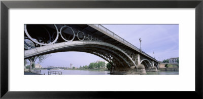 Low Angle View Of Isabel Ii Bridge Over Guadalquivir River, Seville, Spain by Panoramic Images Pricing Limited Edition Print image