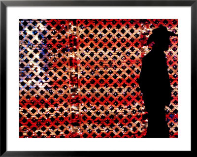 An Man Wearing A Cowboy Hat Walks Past An American Flag Light Display by Brandi Simons Pricing Limited Edition Print image