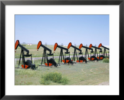 Oil Pumps (Nodding Donkeys) For Sale At Oilfield Supply Merchants, Shelby, Montana, Usa by Tony Waltham Pricing Limited Edition Print image