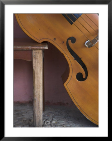 A Counterbass Leaning Against A Wooden Table, Trinidad, Sancti Spiritus Province, West Indies by Eitan Simanor Pricing Limited Edition Print image