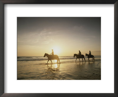 Horseback Riders Silhouetted On A Beach At Twilight, Costa Rica by Michael Melford Pricing Limited Edition Print image