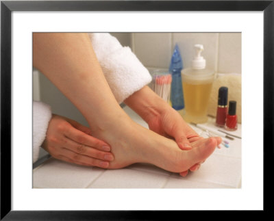 Woman Massaging Foot After Bath by Gary Conner Pricing Limited Edition Print image