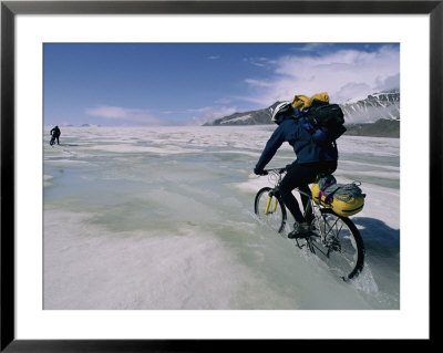 Bikers Travel Across The Rough Terrain And Melt Ice Of The Alaska Range by Bill Hatcher Pricing Limited Edition Print image