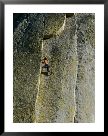 A Rock Climber Scales The Flat Rock Surface Of A Cliff Near Needles, California by Barry Tessman Pricing Limited Edition Print image