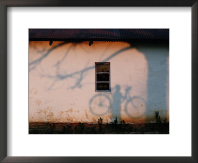 Shadow On A Wall Of A Man Holding A Bicycle by Chris Johns Pricing Limited Edition Print image