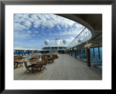 Tables And Chairs On The Pool Deck Of A Cruise Ship by Todd Gipstein Pricing Limited Edition Print image