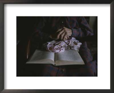 An Old Womans Hands Lie On A Book That She Is Reading by Roy Gumpel Pricing Limited Edition Print image