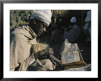 A Man In A Turban Sits Outside Reading by Michael S. Lewis Pricing Limited Edition Print image