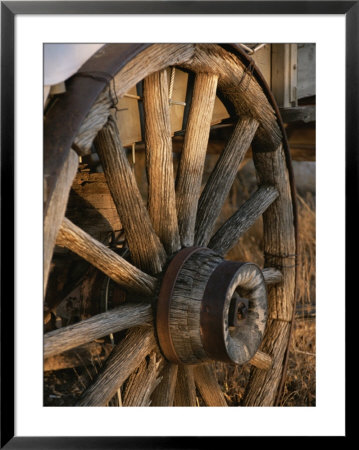 Wagon Wheel On Covered Wagon At Bar 10 Ranch Near Grand Canyon by Todd Gipstein Pricing Limited Edition Print image