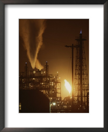 Sparks And Flames Light Up The Night Sky At A Power Plant by Sam Kittner Pricing Limited Edition Print image
