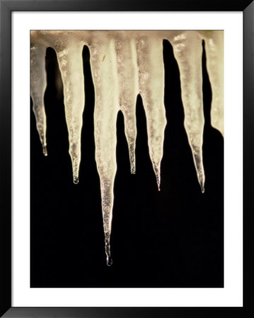 Illuminated Icicles Hang In Front Of A Dark Background by Todd Gipstein Pricing Limited Edition Print image