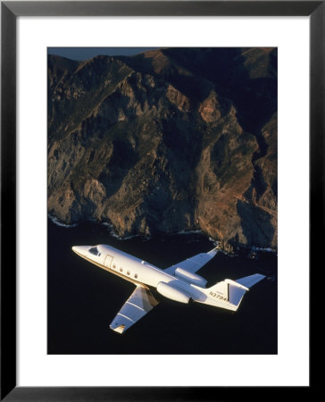 Lear Jet In Flight Over Mountains by Garry Adams Pricing Limited Edition Print image