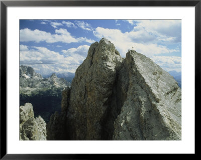 A Climber Standing At The Top Of A Mountain In The Dolomites, Italy by Ed George Pricing Limited Edition Print image