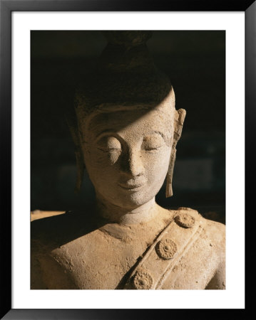 A Statue Of Buddha With Eyes Shut Stands In Half Shadow by Paul Chesley Pricing Limited Edition Print image
