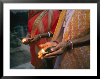 Women Hold Votive Lamps In Their Hands by Karen Kasmauski Pricing Limited Edition Print image