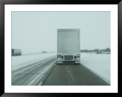Trucks Roll Over An Icy Interstate 80 Near Lincoln, Nebraska by Joel Sartore Pricing Limited Edition Print image