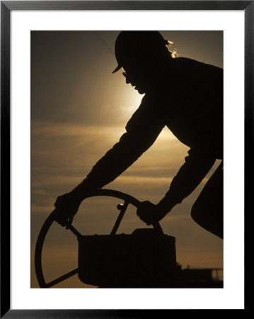 Silhouette Of Oil And Gas Worker Turning Valve by Kevin Beebe Pricing Limited Edition Print image