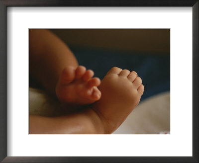 A Close View Of An Infants Tiny Feet by Raul Touzon Pricing Limited Edition Print image