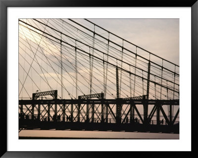 Silhouette Of A Suspension Bridge And Pedestrians by Kenneth Garrett Pricing Limited Edition Print image