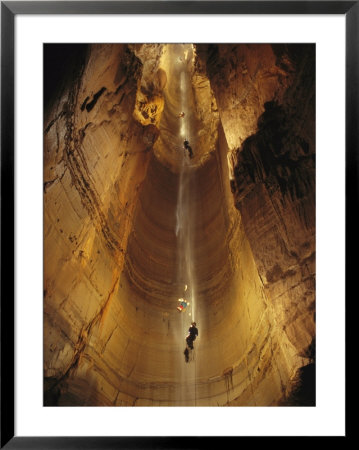 Cavers Cling To A Rope While Exploring The Cave by Stephen Alvarez Pricing Limited Edition Print image