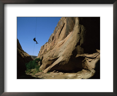 A Silhouetted Climber Rappels Into Kabito Canyon by Bill Hatcher Pricing Limited Edition Print image