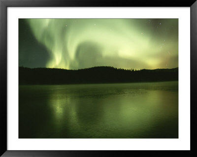 Green And White Streamers Of Aurorae Light Up The Arctic Sky by Paul Nicklen Pricing Limited Edition Print image