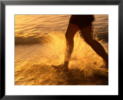 Close View Of A Runners Legs Splashing Through The Surf by Phil Schermeister Pricing Limited Edition Print image