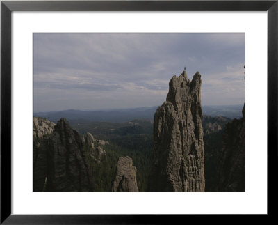 A Climber Stands Atop Khyyam Spire In South Dakota by Bobby Model Pricing Limited Edition Print image