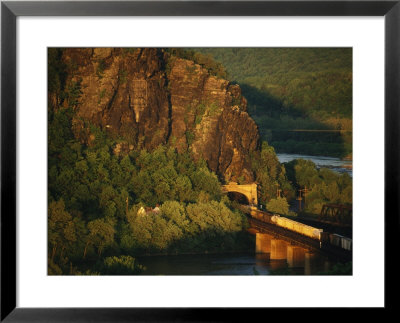 A Train Enters A Tunnel From A Railroad Bridge Over The Potomac River by Joel Sartore Pricing Limited Edition Print image