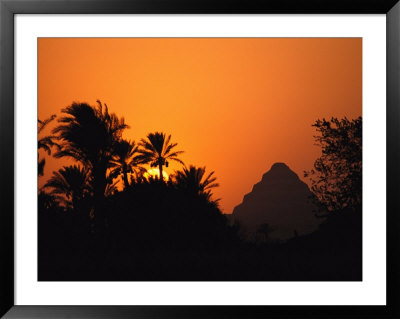 The Step Pyramid Of Djoser Silhouetted By The Setting Sun by Kenneth Garrett Pricing Limited Edition Print image