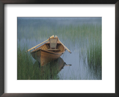 An Adirondack Guide Canoe Floating On Connery Pond At Sunrise by Michael Melford Pricing Limited Edition Print image