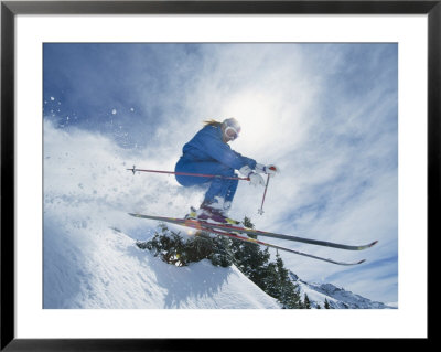 A Skier Crouches As He Takes A Leap Into The Air by Paul Chesley Pricing Limited Edition Print image