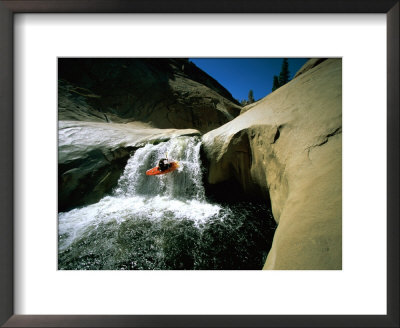 Suspended In Mid-Air, A Kayaker Sails Down Short Waterfall And Is Headed For The White Water Below by Barry Tessman Pricing Limited Edition Print image
