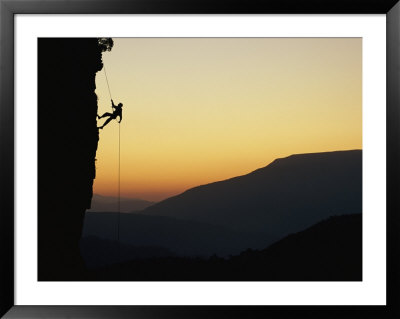 A Man Rappels Down A Cliff by Bill Hatcher Pricing Limited Edition Print image