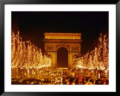 A Night View Of The Arc De Triomphe And The Champs Elysees Lit Up For Christmas by Nicole Duplaix Pricing Limited Edition Print image