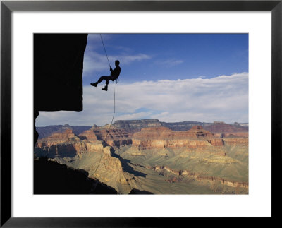 A Man Rappels Down A Cliff In Grand Canyon National Park by Bill Hatcher Pricing Limited Edition Print image