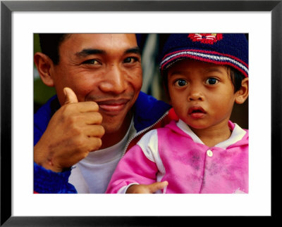 Father And Daughter At Pasar Badung, Denpasar, Indonesia by Tom Cockrem Pricing Limited Edition Print image