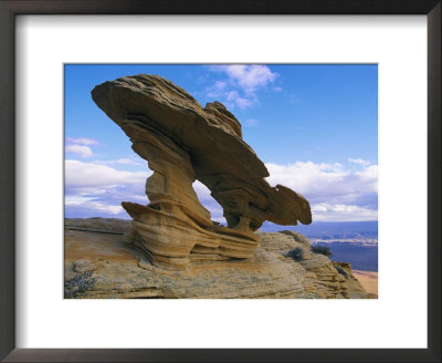 A Rock Formation Shaped By Wind Erosion Overlooks The Grand Canyon by Melissa Farlow Pricing Limited Edition Print image
