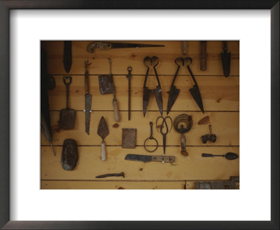 An Assortment Of Hand Tools Hang On A Plank Wall by Raul Touzon Pricing Limited Edition Print image
