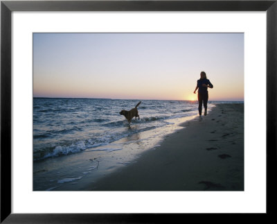 Woman And Dog Running On Beach, Nags Head, North Carolina by Skip Brown Pricing Limited Edition Print image