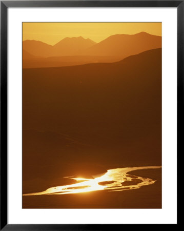 Delta River And The Alaska Range Foothills Glow Orange At Sunset by Michael Melford Pricing Limited Edition Print image