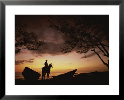 Horseback Rider Silhouetted On A Beach At Twilight, Costa Rica by Michael Melford Pricing Limited Edition Print image