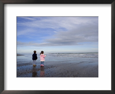 Boy Aged Four And Girl Aged Three On A Black Volcanic Sand Beach In Manawatu, New Zealand by Don Smith Pricing Limited Edition Print image