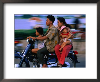 Young Family On Motorcycle., Phnom Penh, Cambodia by John Banagan Pricing Limited Edition Print image