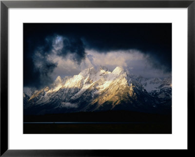 Storm Clouds Over Snow-Capped Mountain, Grand Teton National Park, Usa by Carol Polich Pricing Limited Edition Print image