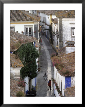 Woman In Narrow Alley With Whitewashed Houses, Obidos, Portugal by John & Lisa Merrill Pricing Limited Edition Print image
